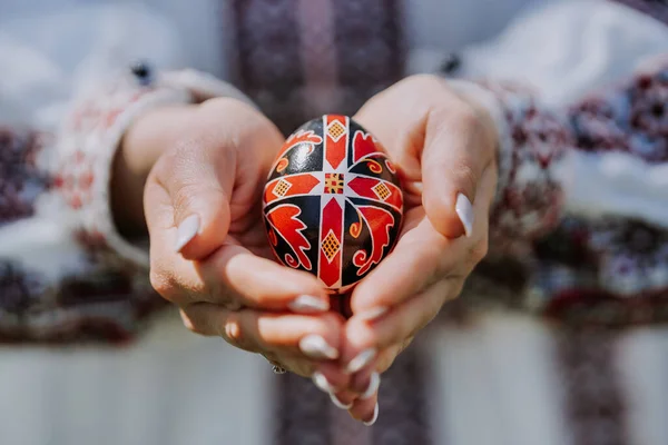 Mulher ucraniana de mãos dadas ovo de Páscoa. Bela decoração eslava geométrica. Senhora em bordado vestido vyshyvanka. — Fotografia de Stock