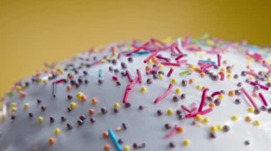 Easter cake decoration with colorful decorative sprinkles on studio background. Homemade cake, christian festive bakery, tradition. Spring religious holiday . High quality 4k footage