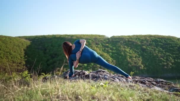 Gomukhasana 'da pratik yapan bir kadın. İnek başı pozu, yüksek dağda yoga. Doğada esneklik egzersizi. Güçlü kadın boyun ve sırt güçlendiriyor. — Stok video