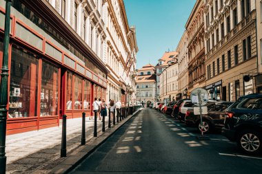 Beautiful cozy narrow street in old european city of Prague. Amazing architecture, historical facades of traditional buildings. High quality photo