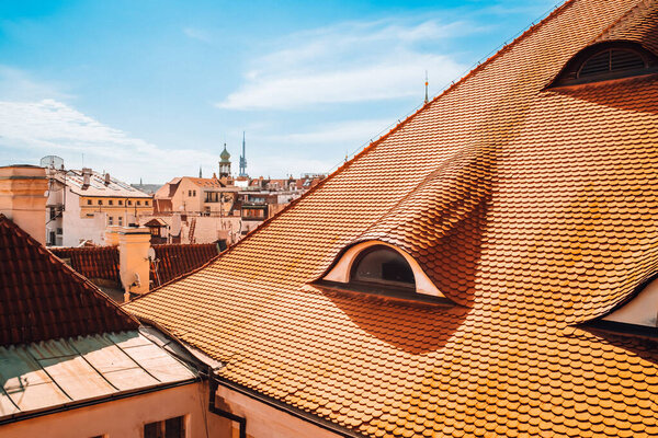 View from terrace on Prague buildings roofs with typical traditional red roof tiles. Czech republic, european city. High quality photo