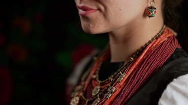 Authentic woman in traditional ukrainian jewelry necklace and costume. Lady in national costume - vyshyvanka and ancient coral beads, Zgarda. High quality 4k footage