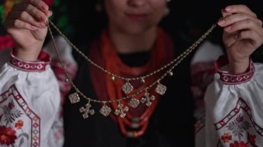 Ukrainian woman demonstrating authentic traditional jewelry necklace of Ukraine - Zgarda - archaic hutsul neck ornament of status religious purpose. High quality 4k footage