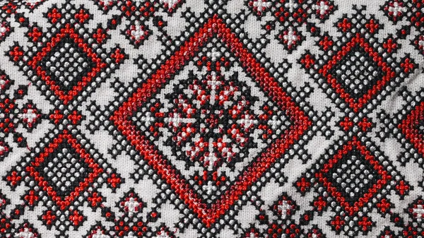 Handmade embroidery on Ukrainian shirt. Geometric ornaments, ancient traditional authentic clothes of Ukrainians. Colorful screen saver, vyshyvanka. Ethnic craft. High quality photo