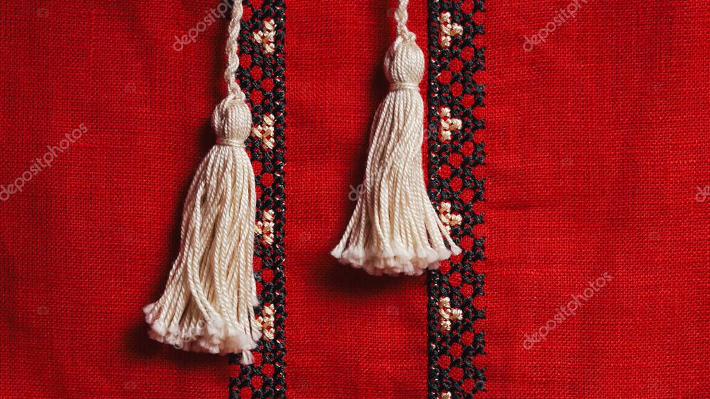Handmade embroidery on Ukrainian shirt. Geometric ornaments, ancient traditional authentic clothes of Ukrainians. Red screen saver, vyshyvanka. Ethnic craft. High quality photo