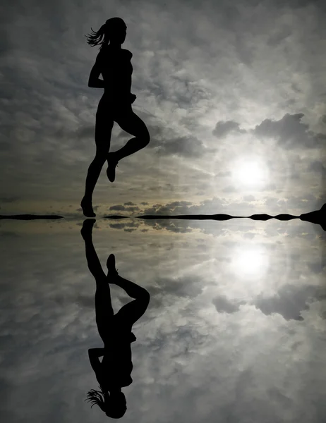 Female runner silhouette against the sunset Stock Image