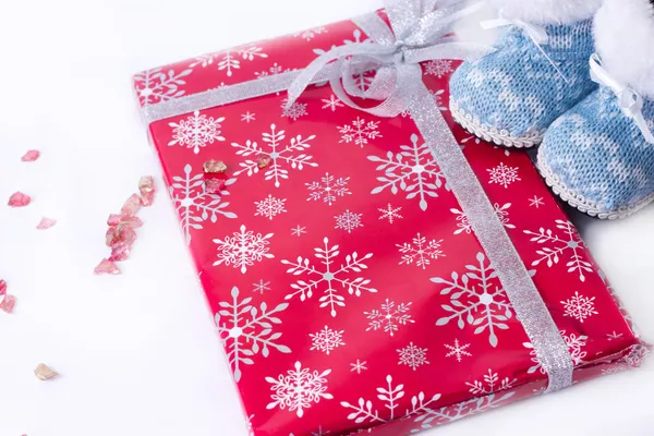 Christmas winter boots wrapped around a gift — Stock Photo, Image