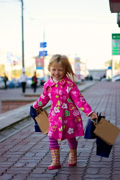 Cheerful blond girl 3 years old with shopping — Stock Photo, Image