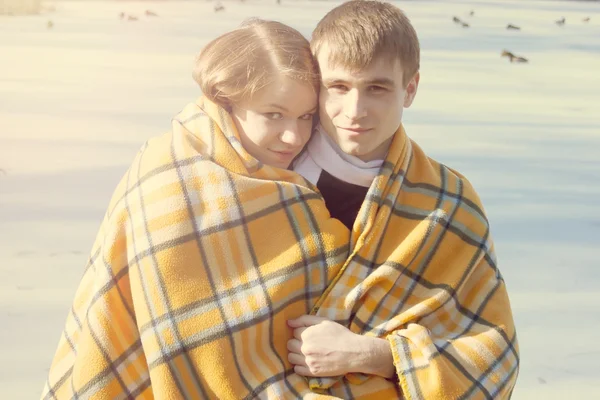 Young couple winter wrapped in blanket — Stock Photo, Image