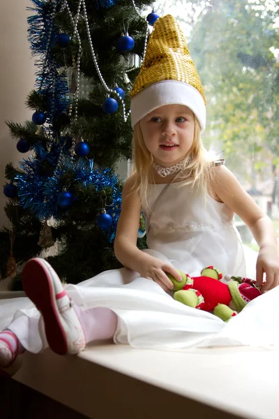 Portrait of happy girl in Christmas tree — Stock Photo, Image