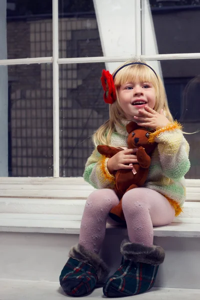 Little girl in a knitted sweater and tights — Stock Photo, Image