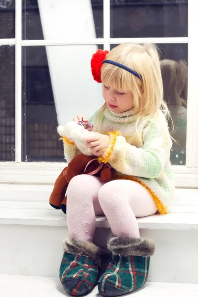 Little girl in knitted sweater with a bandage — Stock Photo, Image