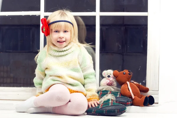 Blonde little girl in knitted sweater — Stock Photo, Image