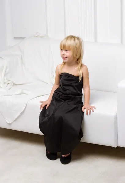 Little girl trying on the big shoes — Stock Photo, Image