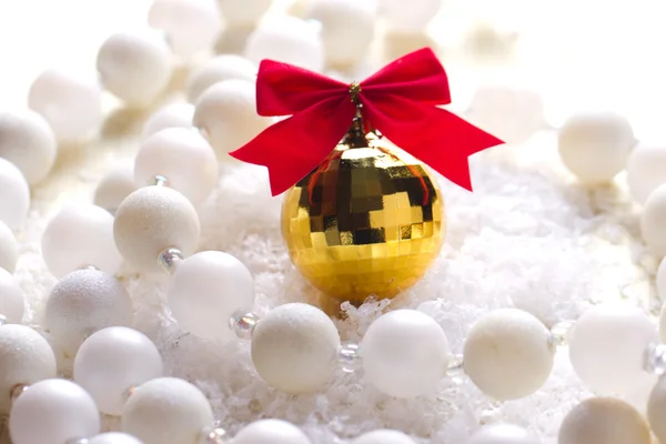 Golden ball with a red bow — Stock Photo, Image