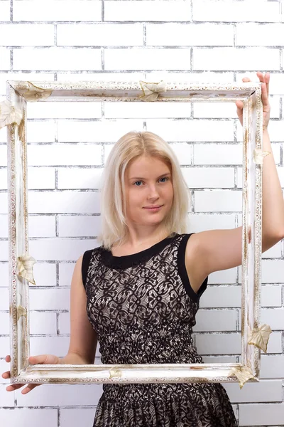 Beautiful blonde in white dress with a frame — Stock Photo, Image