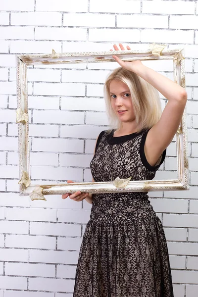 Beautiful blonde in white dress with a frame — Stock Photo, Image