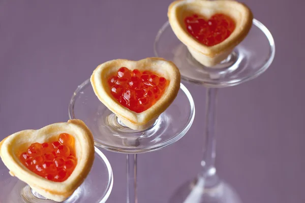 Tartlets with heart-shaped eggs — Stock Photo, Image