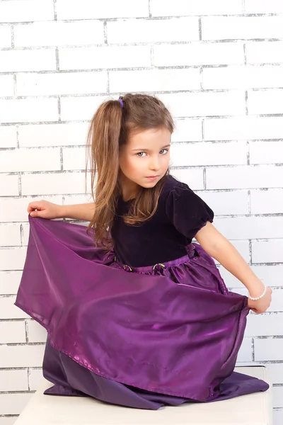 Girl in a purple dress — Stock Photo, Image