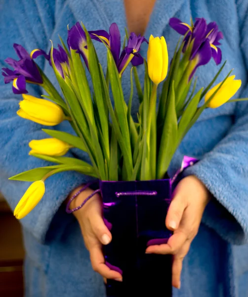 Mulher segurando um buquê de tulipas e íris — Fotografia de Stock