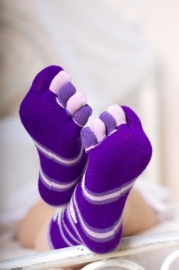 Female legs in purple socks clipart