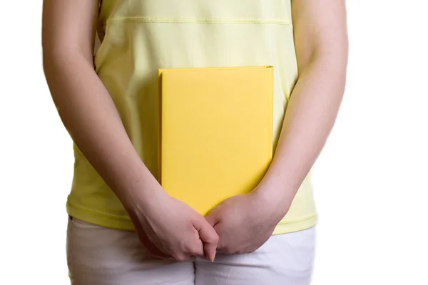 Girl in the shirt holding a book — Stock Photo, Image