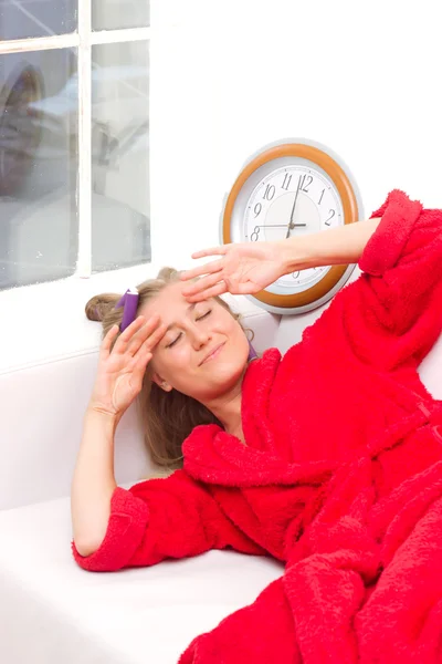 Sleepy woman with a clock — Stock Photo, Image