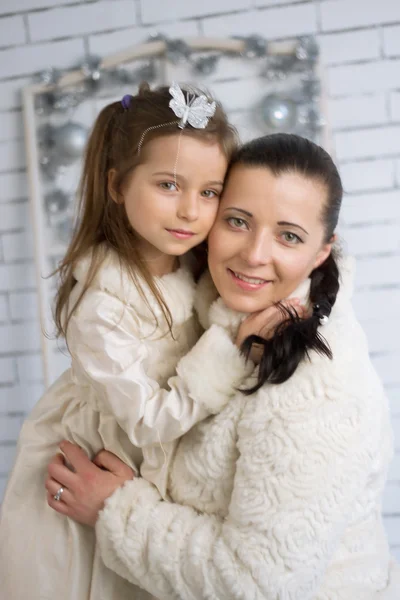 Mom and daughter in the winter dresses — Stock Photo, Image