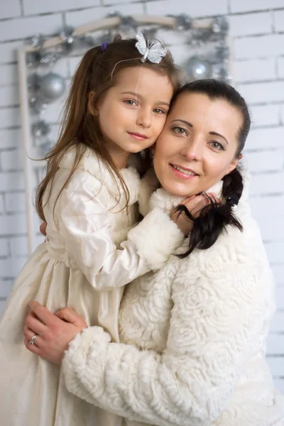 Mom and daughter in the winter dresses — Stock Photo, Image