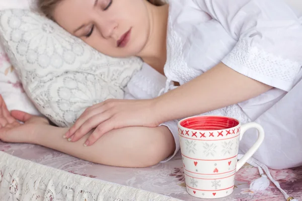 Mulher loira acordando com xícara de café no quarto — Fotografia de Stock