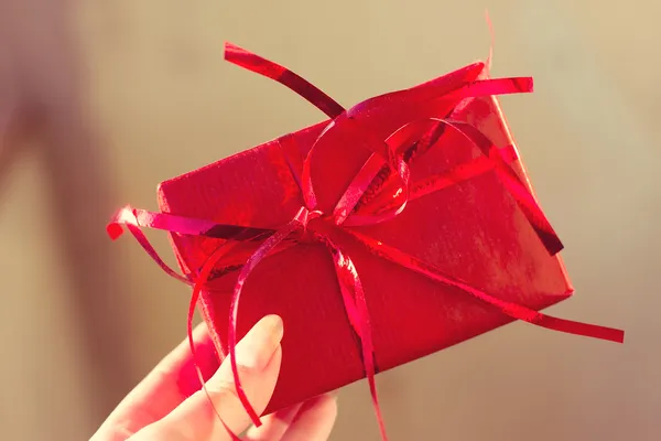 Female hands holding small gift — Stock Photo, Image