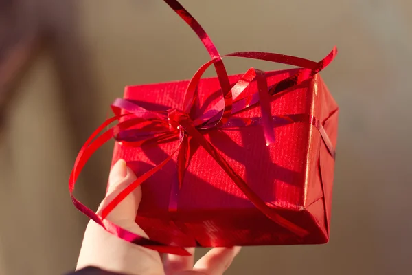 Female hands holding small gift — Stock Photo, Image