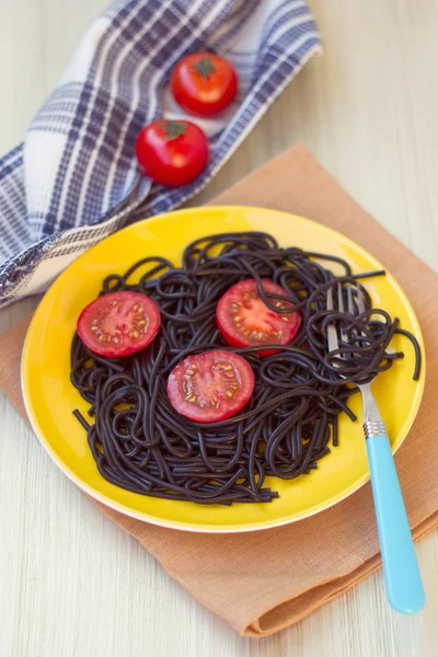 Black pasta  with tomatoes — Stock Photo, Image