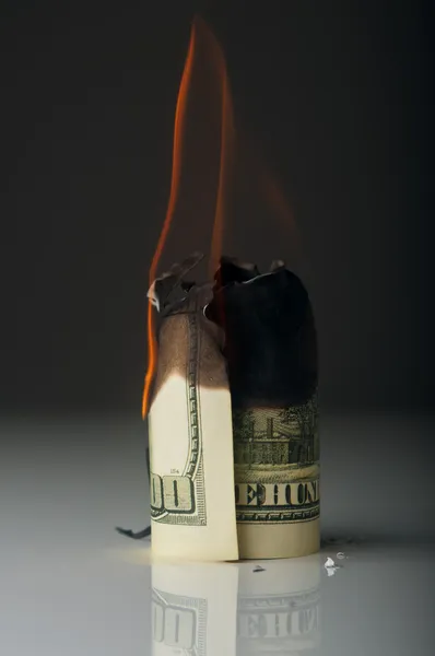 dollar note burning in fire