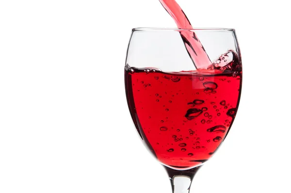 Pouring red wine into a glass — Stock Photo, Image