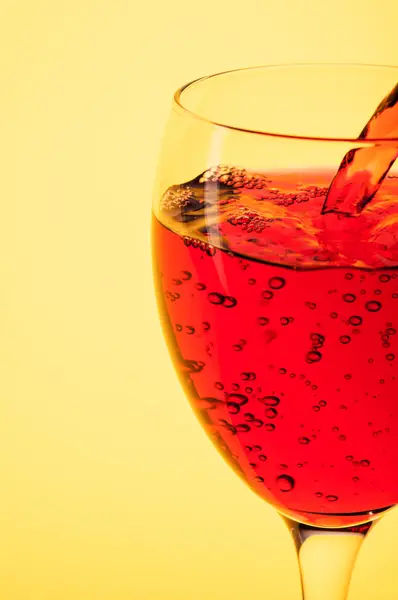 Pouring red wine into a glass — Stock Photo, Image