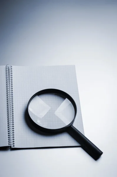 Magnifying glass and notebook — Stock Photo, Image