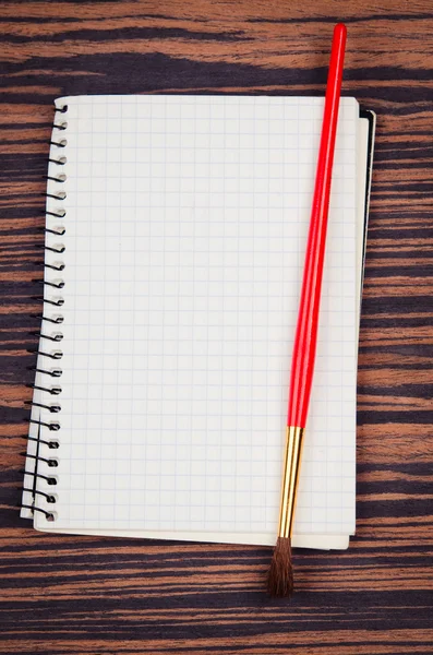Notebook with brush — Stock Photo, Image