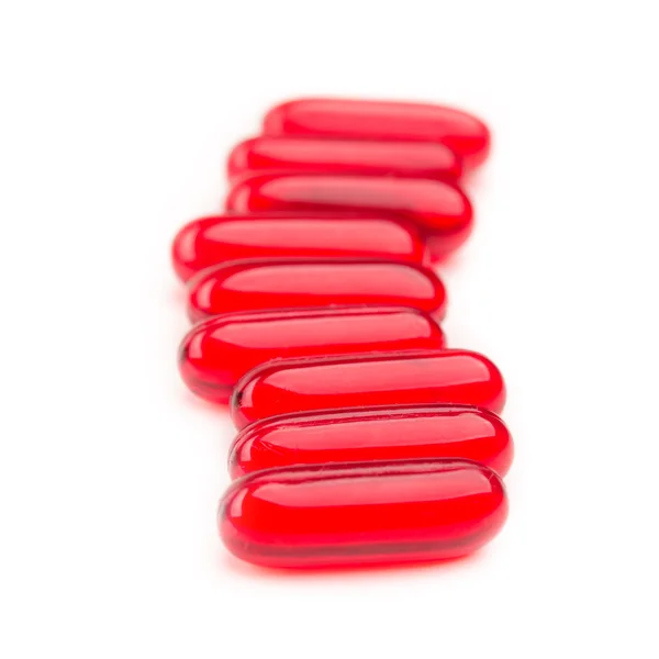 Pila de píldoras rojas aisladas — Foto de Stock