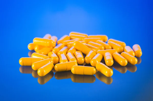 Group of medical yellow capsules — Stock Photo, Image