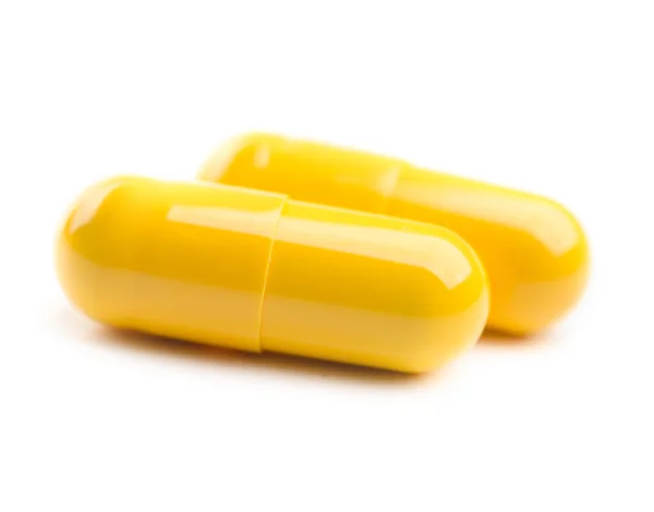 Closeup of two yellow pills — Stock Photo, Image