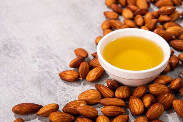 Natural fresh almond oil in a bowl. healthy diet food concept.