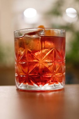 Glass of whiskey sour cocktail in a restaurant table.