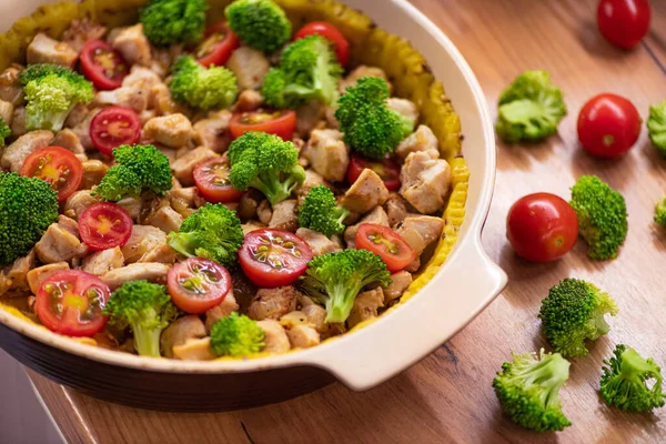 Homemade pie with green broccoli and cherry tomatoes, chicken. Proper nutrition. diet background.