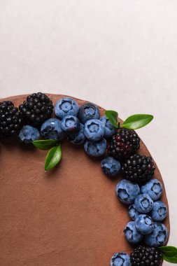 Sweet chocolate cake with forest berries, blackberry, blueberry on top. 