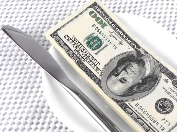 Dollars money on plate with knife — Stock Photo, Image