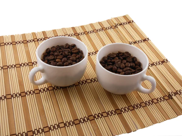 Coffee beans, coffee cup on bamboo background — Stock Photo, Image