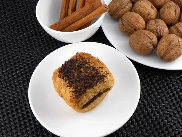 Cake, walnut and cinnamon on white plate — Stock Photo, Image