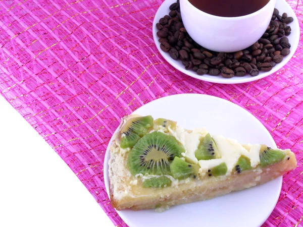 Coffee cup and slice of kiwi tart — Stock Photo, Image