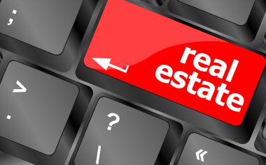 Real Estate concept. hot key on computer keyboard with Real Estate words clipart